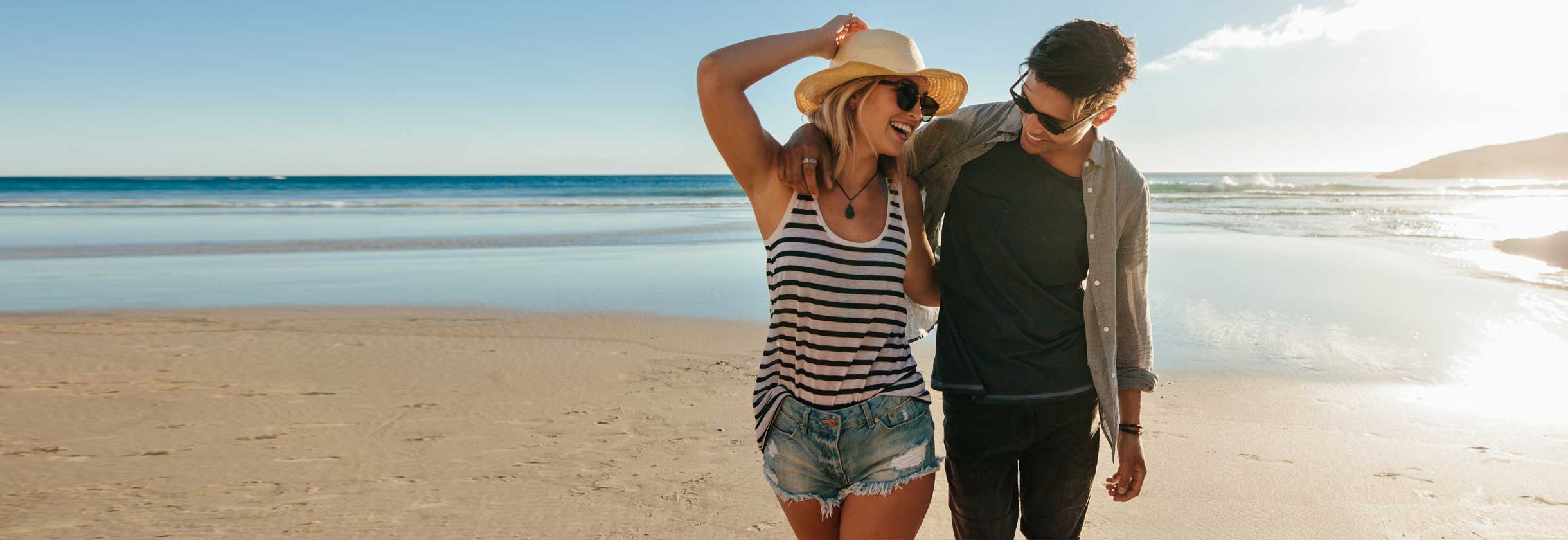 Friends walking on beach.